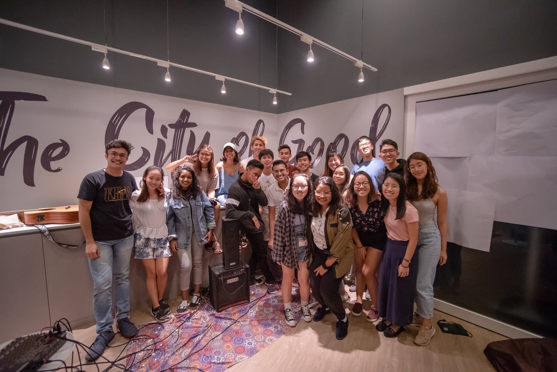 A group of musicians posing together at a live show
