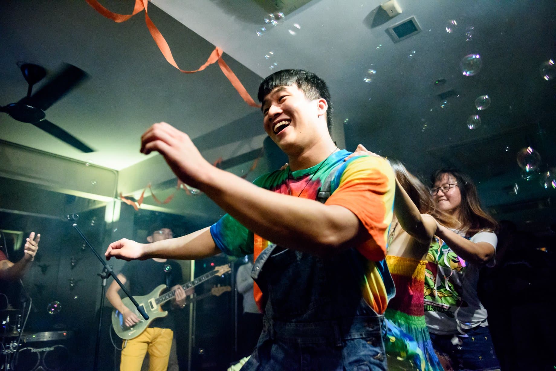 Musicians performing under stage lights